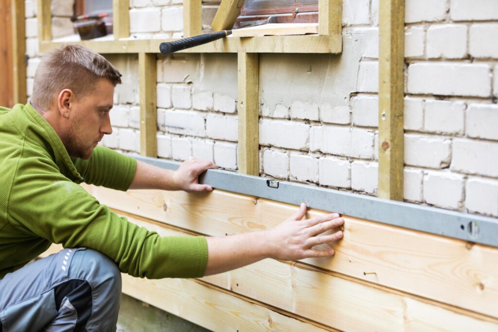 man installing wall sidings